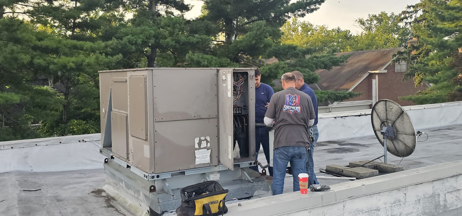 Shepherd HVAC technicians making final connections on a new rooftop HVAC unit