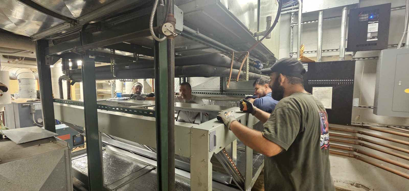 Shepherd HVAC technician fastening panels on a new air handling unit