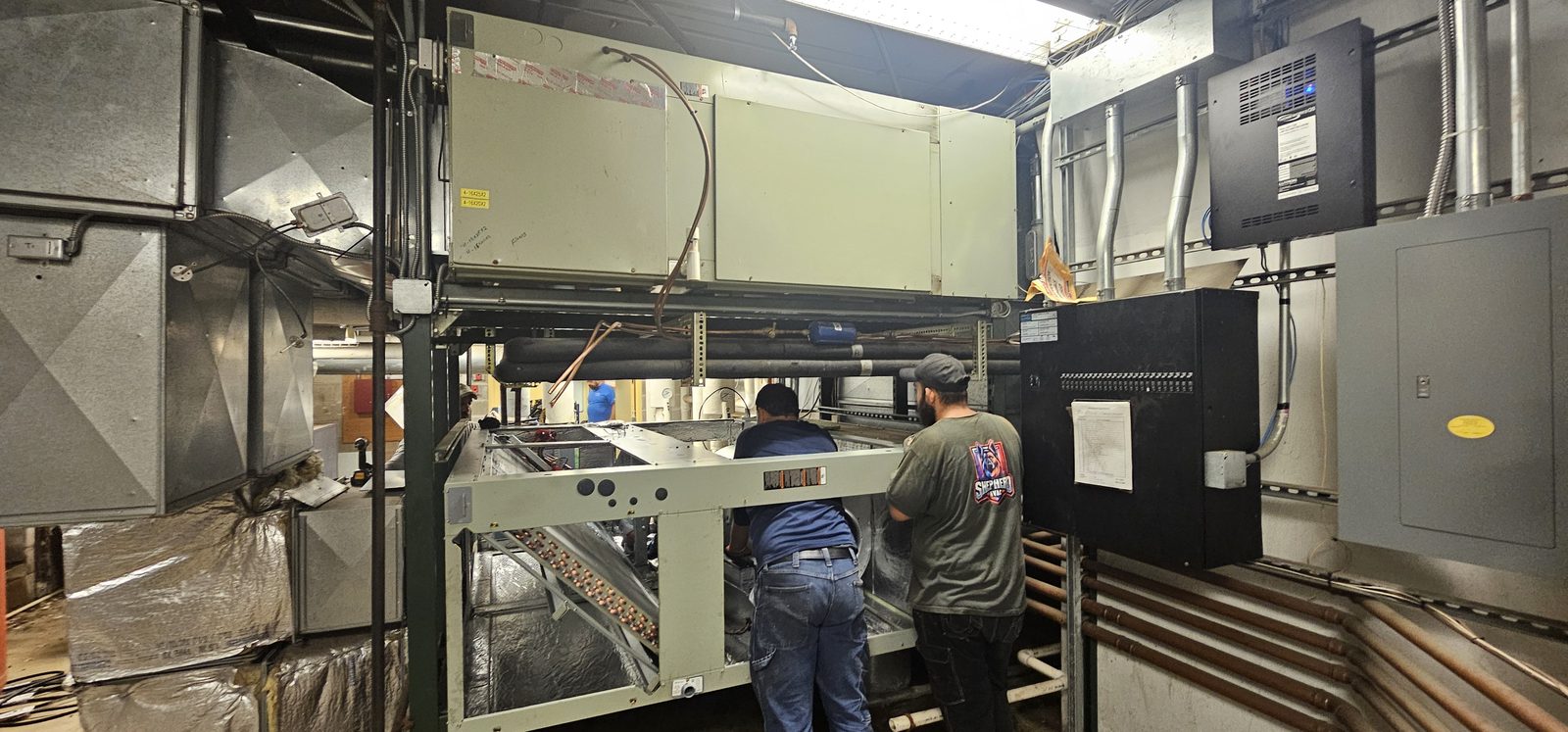 Custom air handling unit assembled in place inside a commercial mechanical space
