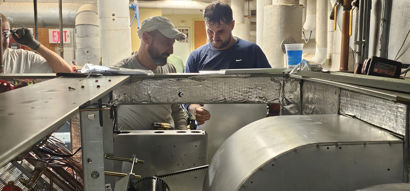 Shepherd HVAC technicians fabricating and fitting sheet metal ductwork