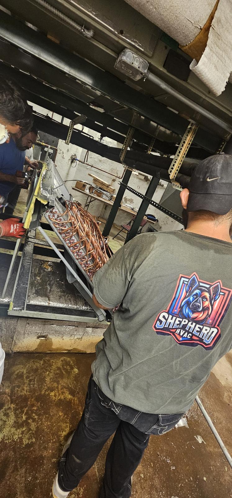 Shepherd HVAC technicians working together to assemble a custom air handler