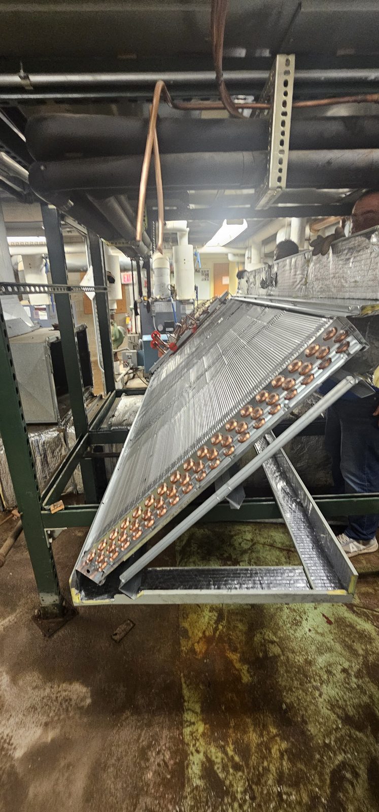 Evaporator coil section staged inside a mechanical room before installation