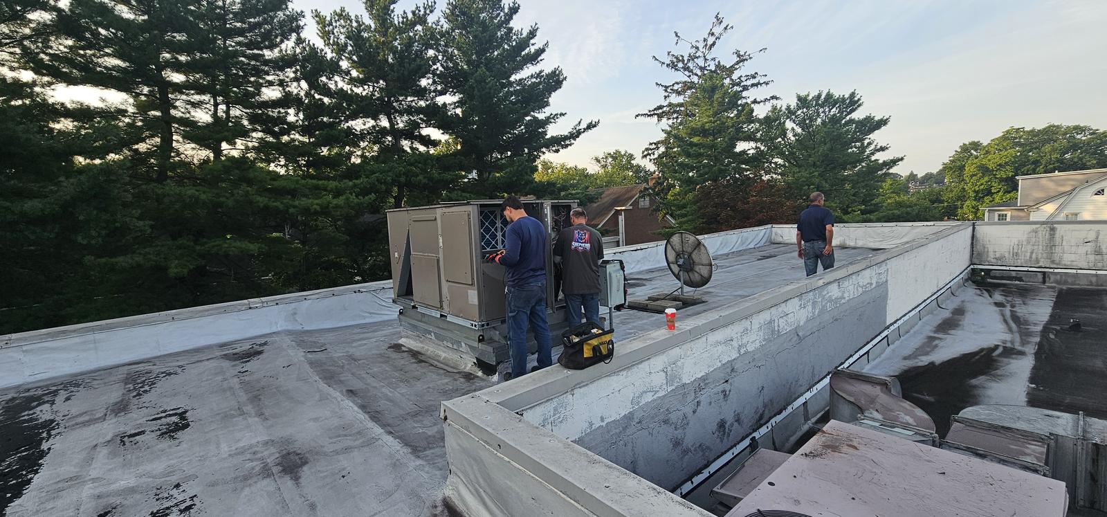 Shepherd HVAC crew setting a new packaged rooftop unit on a commercial roof